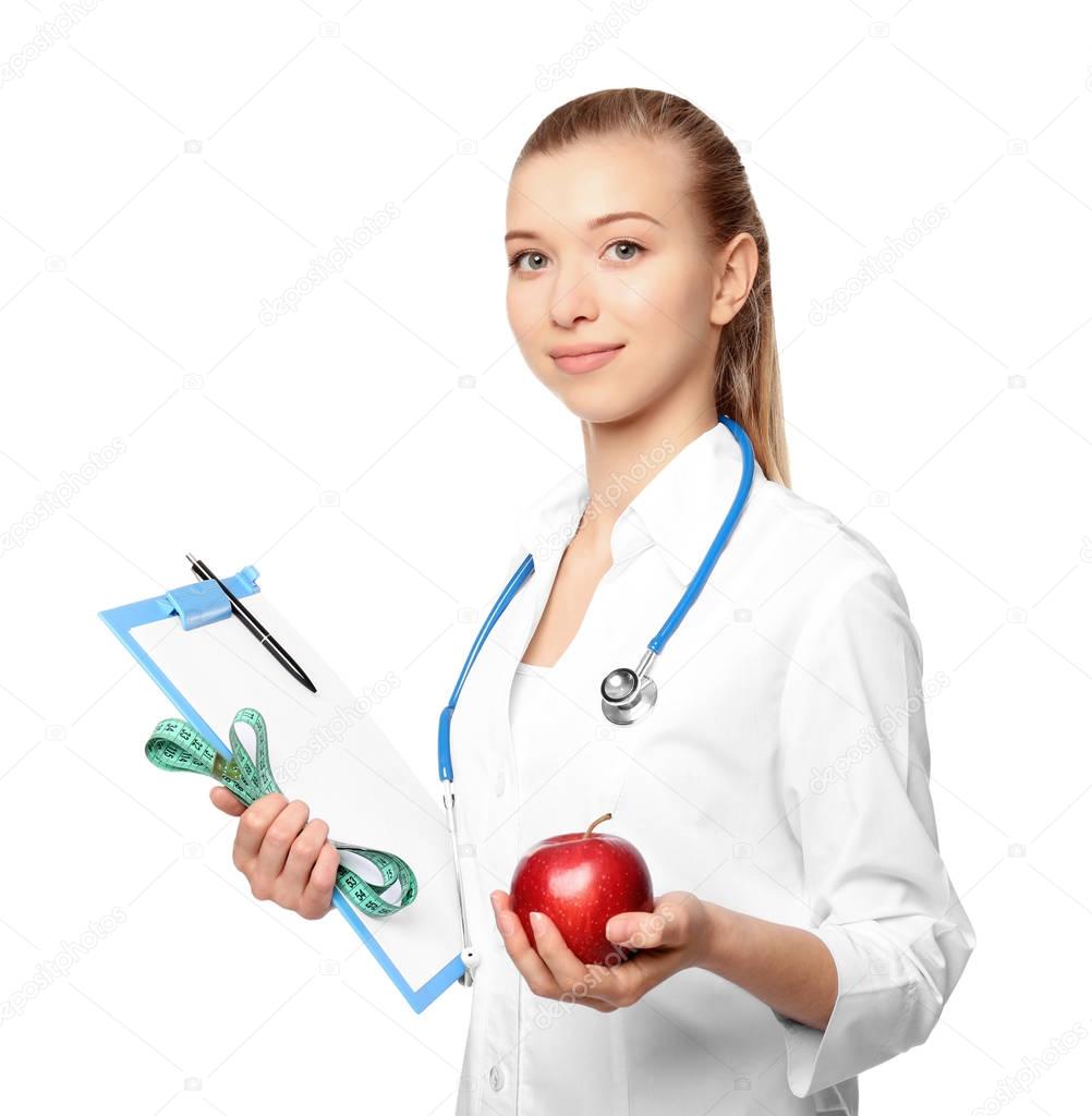 Diet concept. Female nutritionist with apple and clipboard on white background