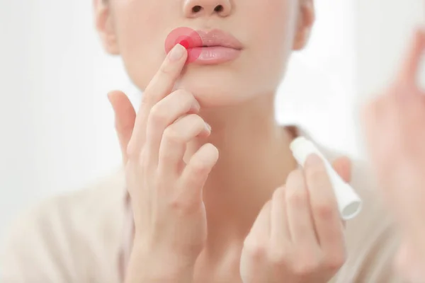 Mujer aplicando bálsamo en los labios — Foto de Stock