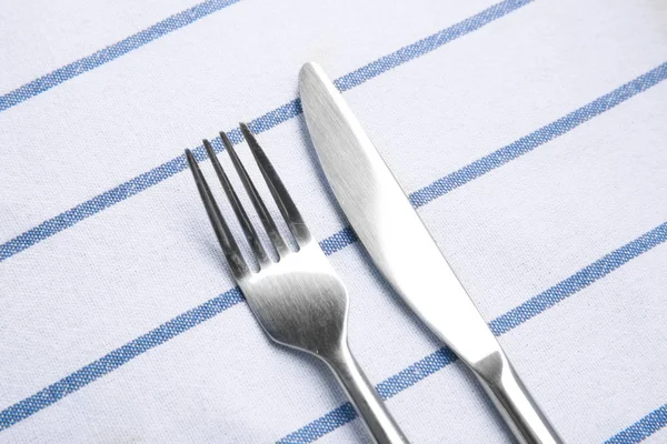 Fork and knife on linen tablecloth — Stock Photo, Image