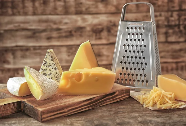 Grater and cheese on background — Stock Photo, Image
