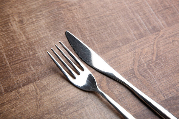 Fork and knife on wooden table