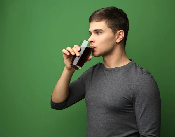 Young man drinking juice — Stock Photo, Image