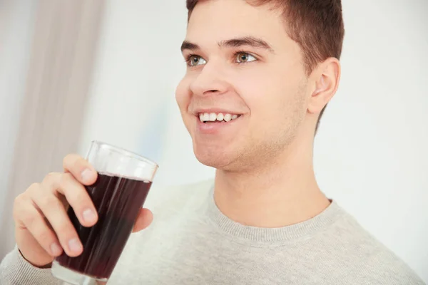 Young man drinking juice — Stock Photo, Image