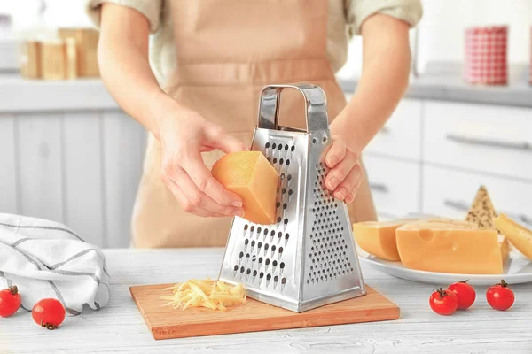 Woman grating cheese — Stock Photo, Image