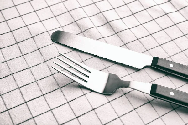 Fork and knife on linen tablecloth — Stock Photo, Image