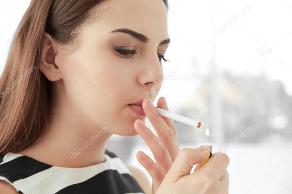 Young woman smoking cigarette 