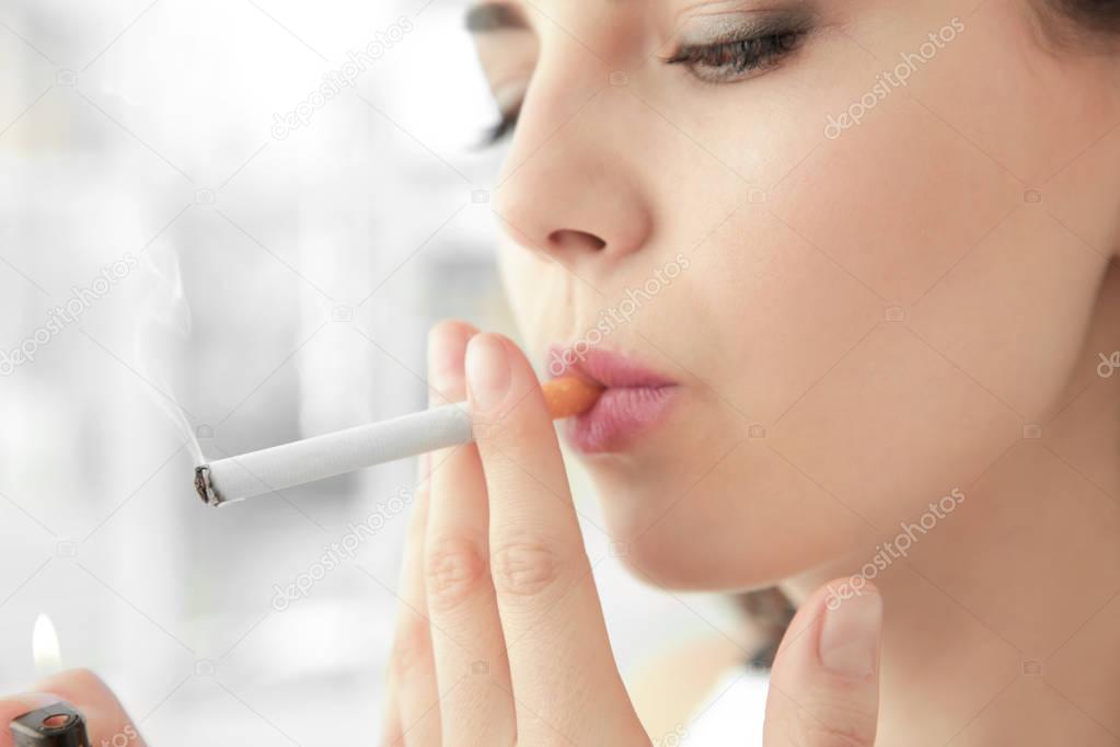 Young woman smoking cigarette 