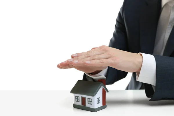 Male hands covering toy house — Stock Photo, Image