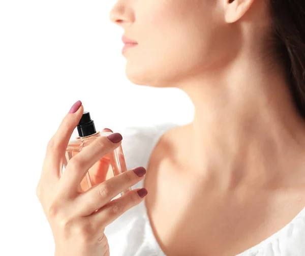 Beautiful young woman with bottle of perfume — Stock Photo, Image