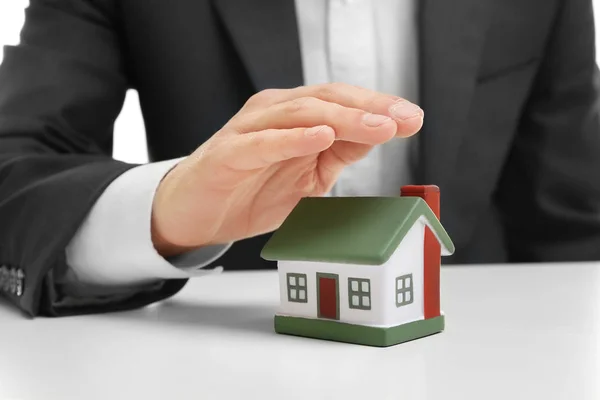 Man covering with hand toy house — Stock Photo, Image