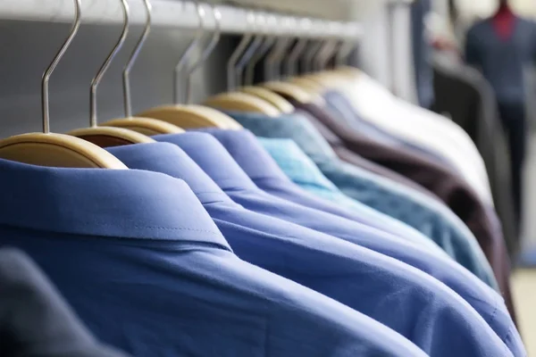 Rack with shirts in shop — Stock Photo, Image