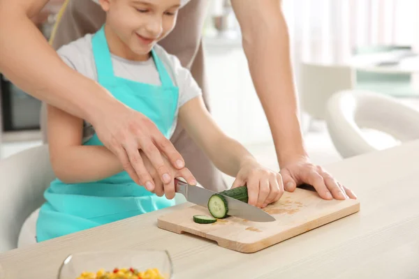 Dad and son cooking at home