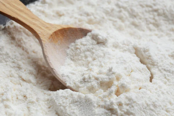 Wooden spoon in flour — Stock Photo, Image