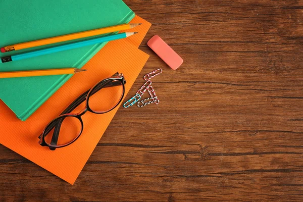 Glasses and stationery on wooden background — Stock Photo, Image