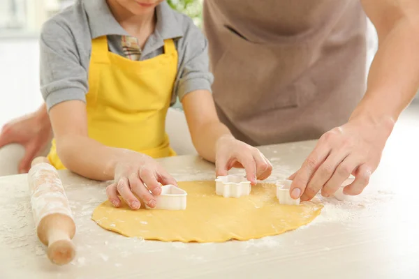 Dad and son cooking at home, closeup