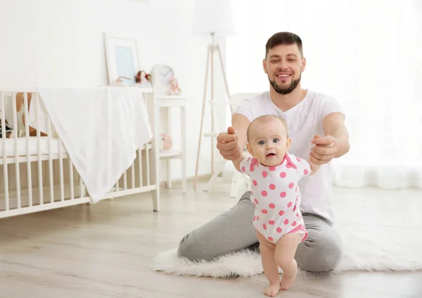 Father sitting with cute baby daughter — Stock Photo, Image