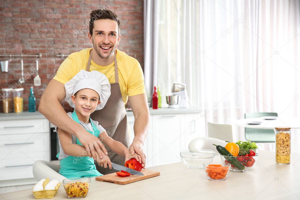 Dad and son cooking at home