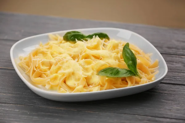 Plate with delicious pasta and cheese sauce — Stock Photo, Image