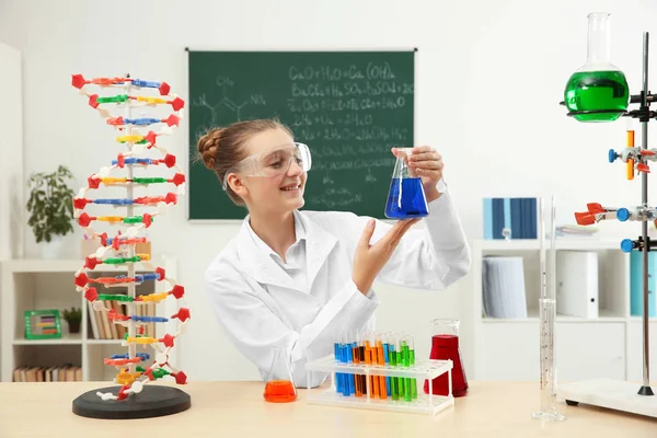 School girl sitting at table in chemistry class — Stock Photo, Image