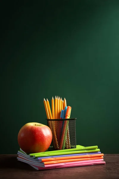 Stationery and apple on notebooks — Stock Photo, Image