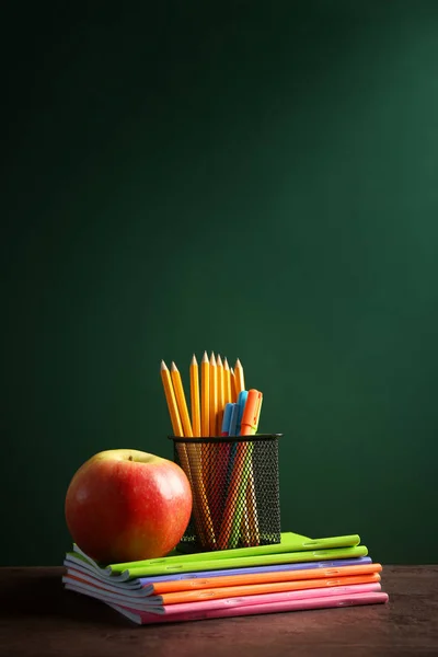 Papelería y manzana en cuadernos —  Fotos de Stock