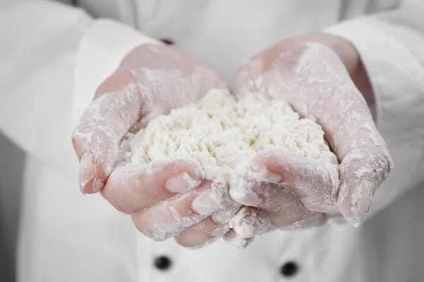 Woman holding heap of flour — Stock Photo, Image