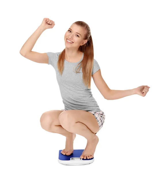Young woman sitting on scales — Stock Photo, Image