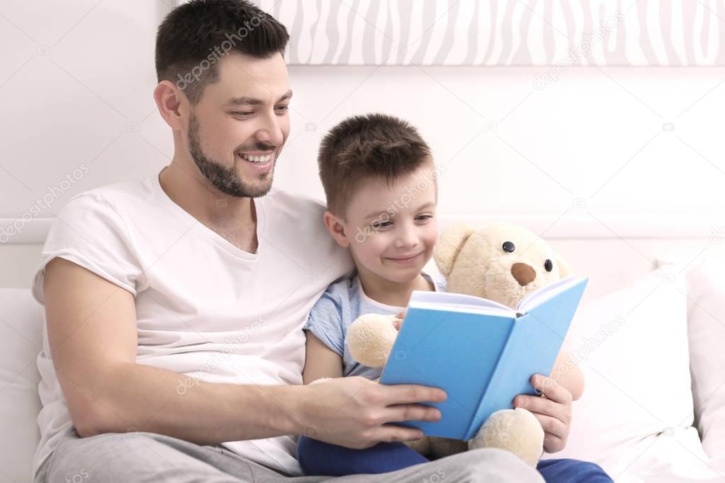 Dad and son reading book 