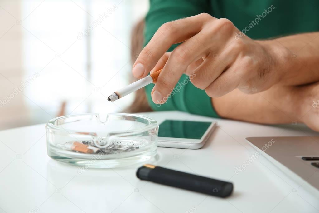 Male hand ashing his cigarette 