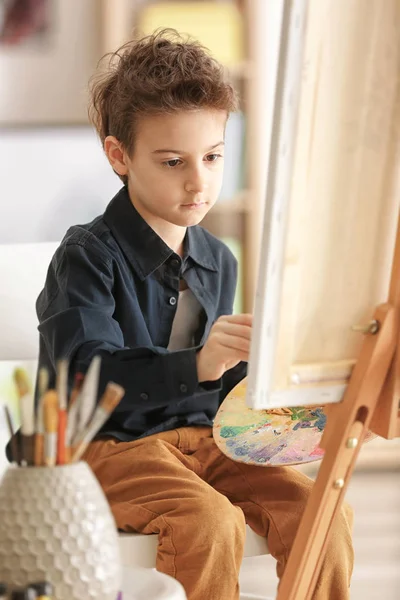 Cute little artist painting picture in studio — Stock Photo, Image