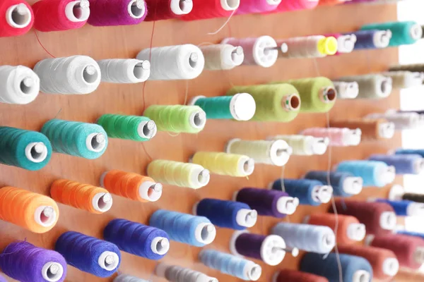 Spools with threads on rack — Stock Photo, Image