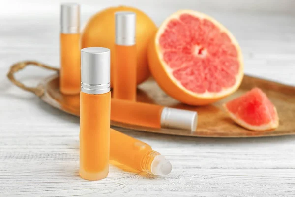 Bottles of perfume and citrus fruit — Stock Photo, Image