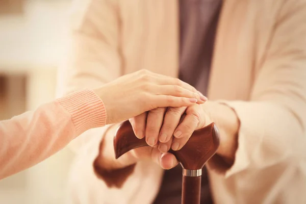 Old and young women holding hands — Stock Photo, Image