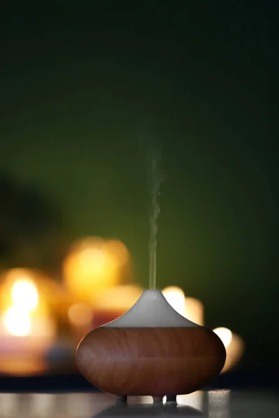 Difusor de aceite de aroma sobre fondo de velas borrosas — Foto de Stock