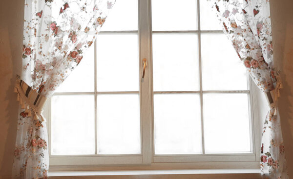 Large wooden window with curtains  