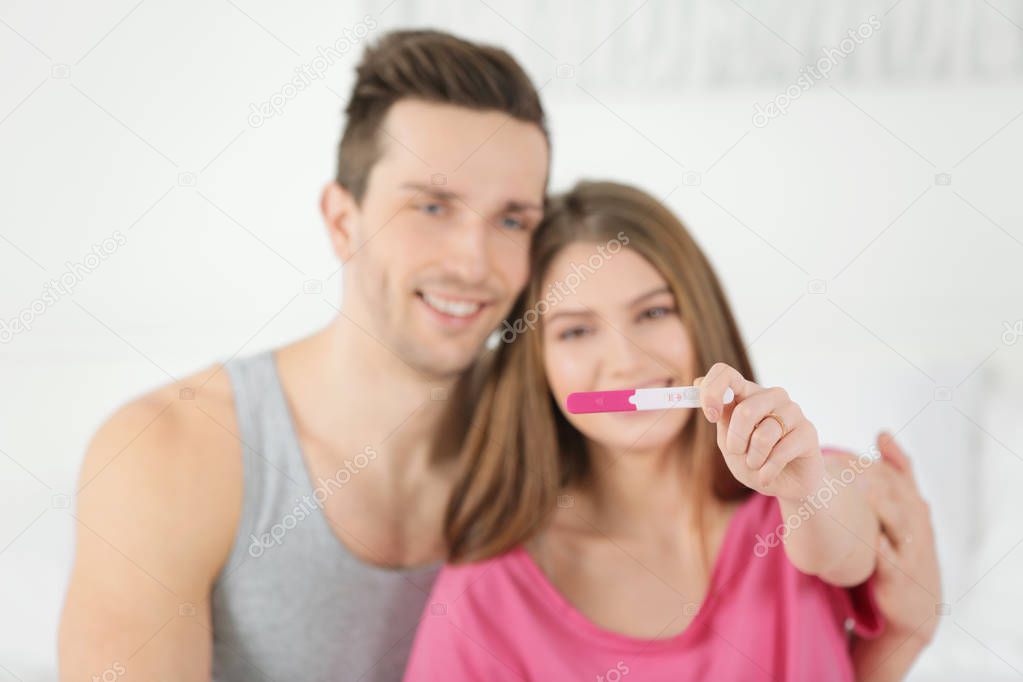 couple holding pregnancy test