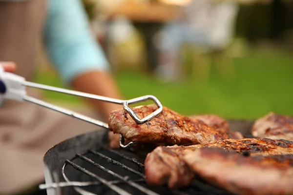 Preparing of steaks on barbecue grill — Stock Photo, Image