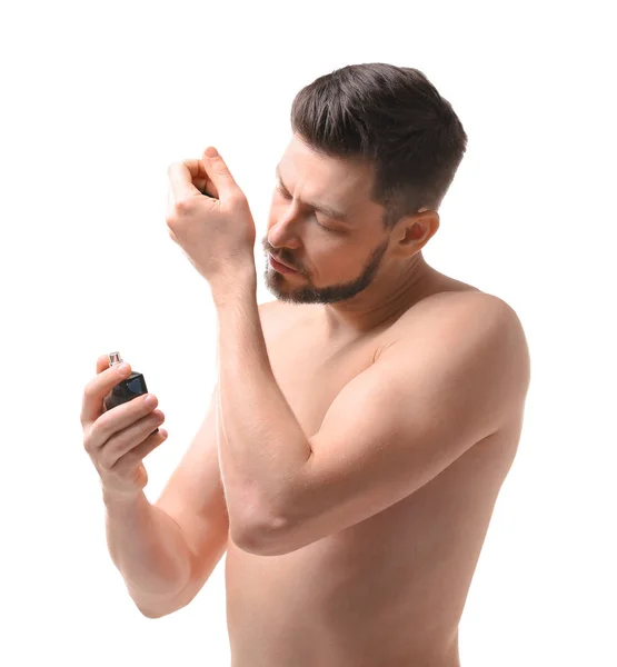 Handsome young man using perfume — Stock Photo, Image