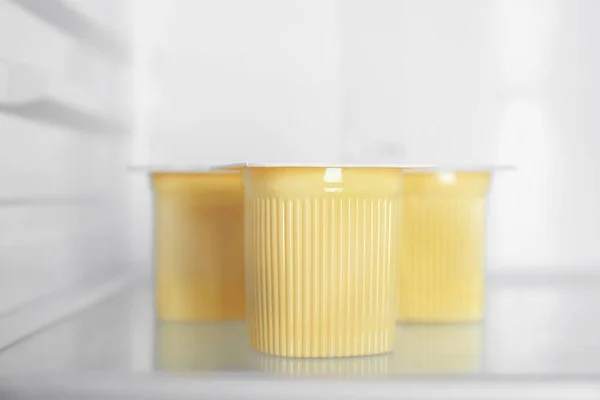 Plastic cups with yogurt