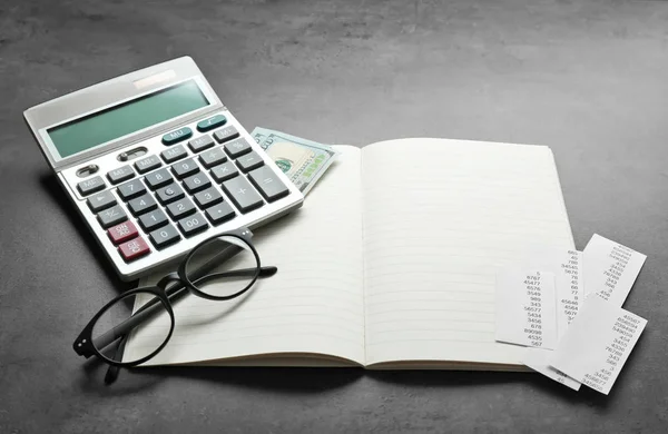 Calculator and notebook with glasses — Stock Photo, Image