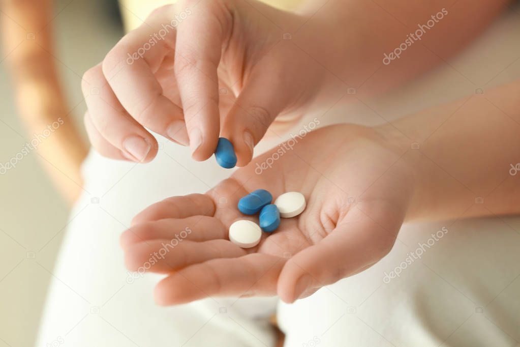 Hands of woman with pills