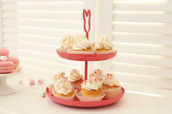 Stand with tasty cupcakes on table, closeup — Stock Photo, Image