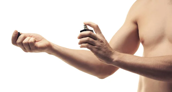 Handsome young man using perfume — Stock Photo, Image