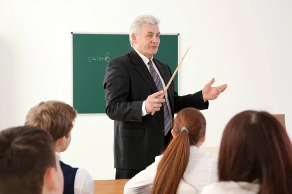 Pupils listening to teacher in classroom