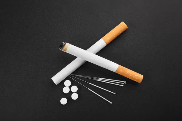 Cigarettes with needles and pills — Stock Photo, Image