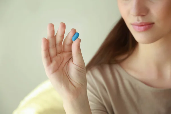 Beautiful young woman with pill — Stock Photo, Image