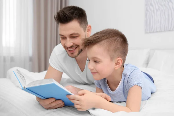 Dad and son reading interesting book — Stock Photo, Image