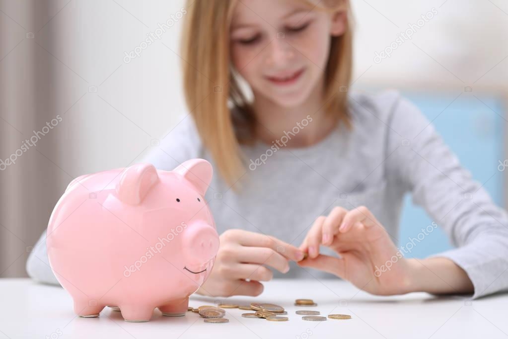 Cute girl with piggy bank 