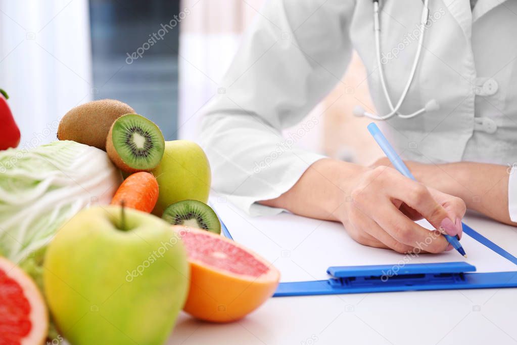 Nutritionist doctor writing diet plan 
