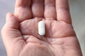 Hand of senior woman with pill